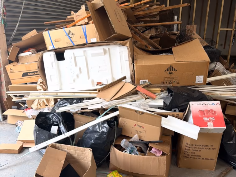 Before: cardboard, packaging and mixed rubbish cleared from a commercial unit