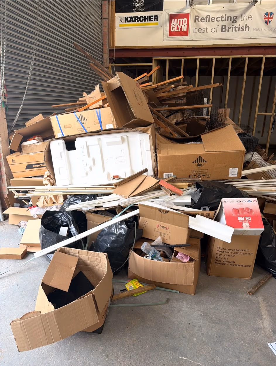 Before: cardboard, packaging and mixed rubbish cleared from a commercial unit