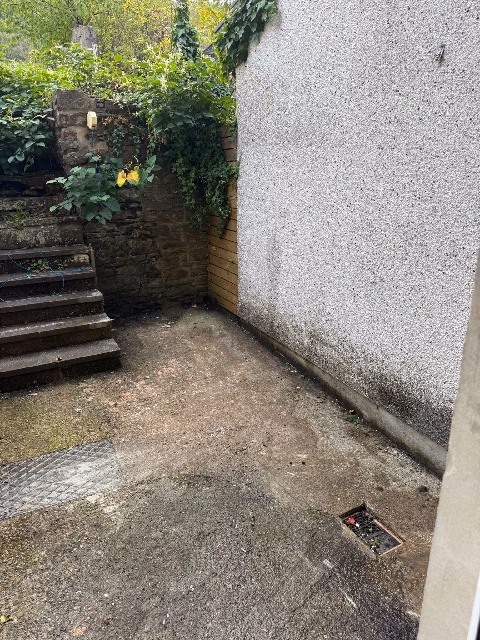 After: old bathroom suite and household waste cleared from a rear garden