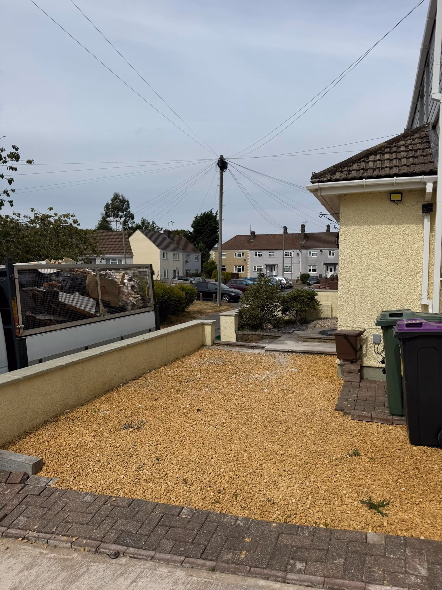 After: bagged waste and timber cleared from a front garden