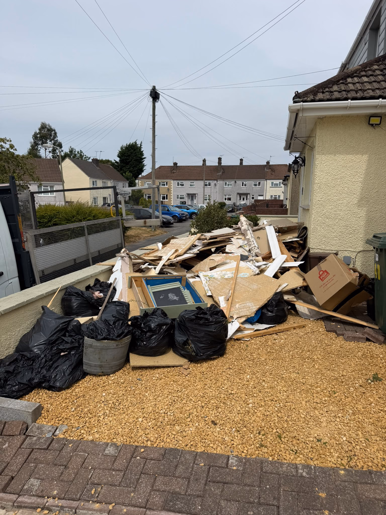 Before: bagged waste and timber cleared from a front garden