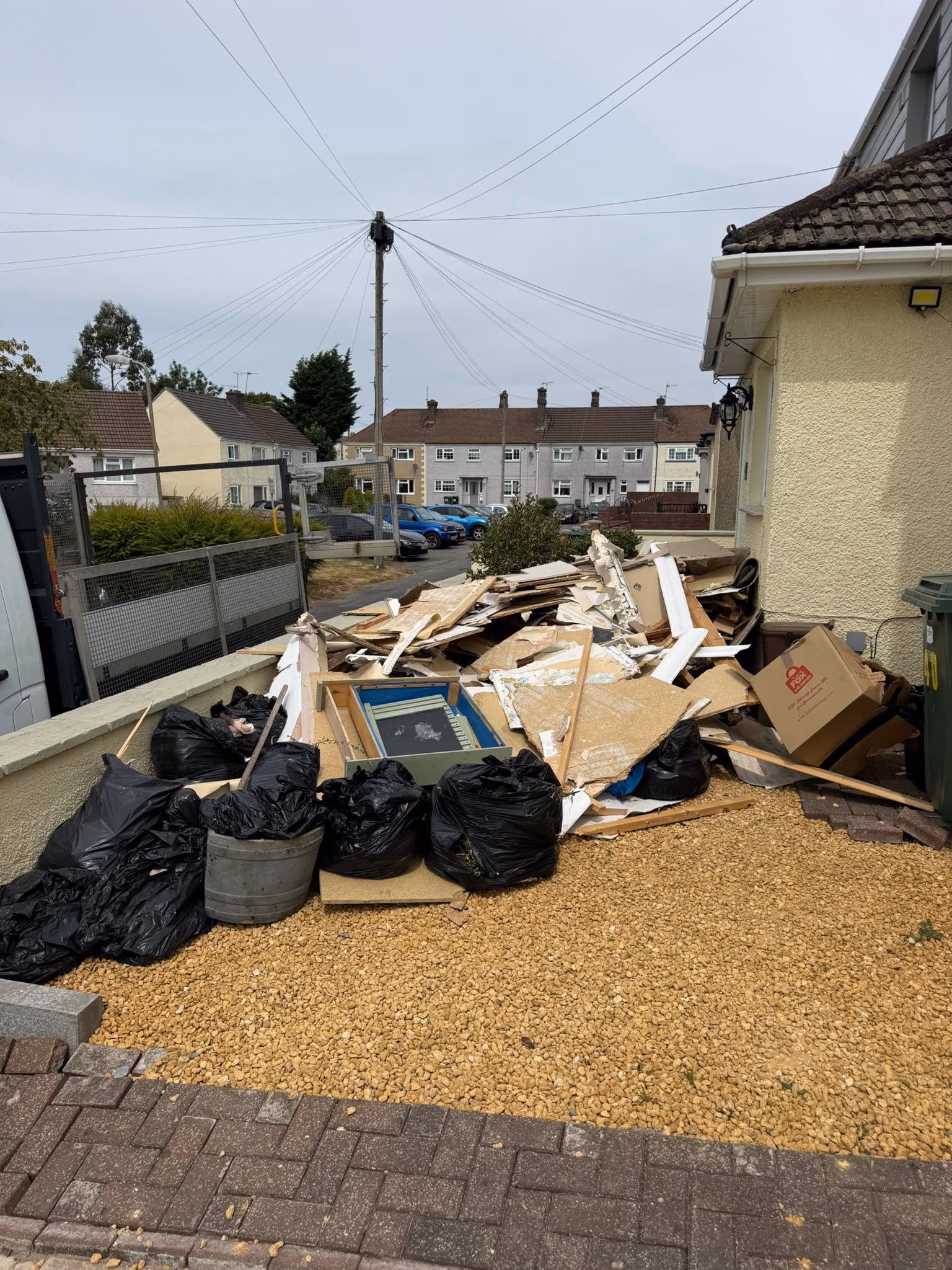 Before: bagged waste and timber cleared from a front garden