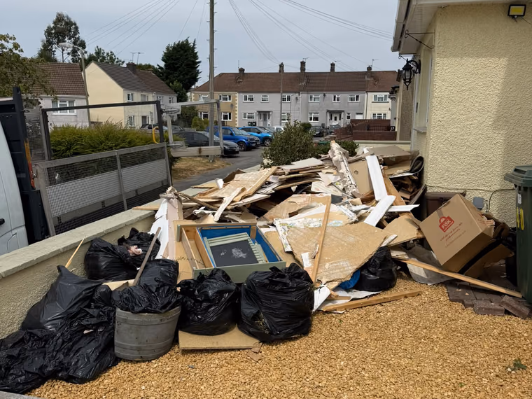 Before: bagged waste and timber cleared from a front garden