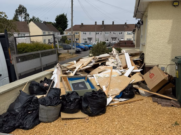 Before: bagged waste and timber cleared from a front garden